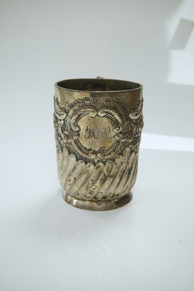 A late Victorian demi- wrythened fluted and embossed christening mug, by Josiah Williams & Co, London, 1892, 94mm, 4.6oz. Condition - poor to fair